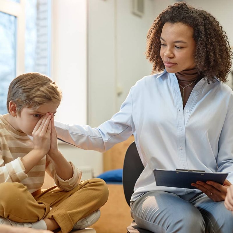 female-therapist-comforting-troubled-little-boy-2025-03-05-11-26-35-utc (1)